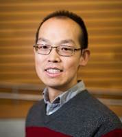 A person wearing glasses and a sweater

Description automatically generated