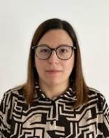 A person with glasses and a black and white shirt

Description automatically generated