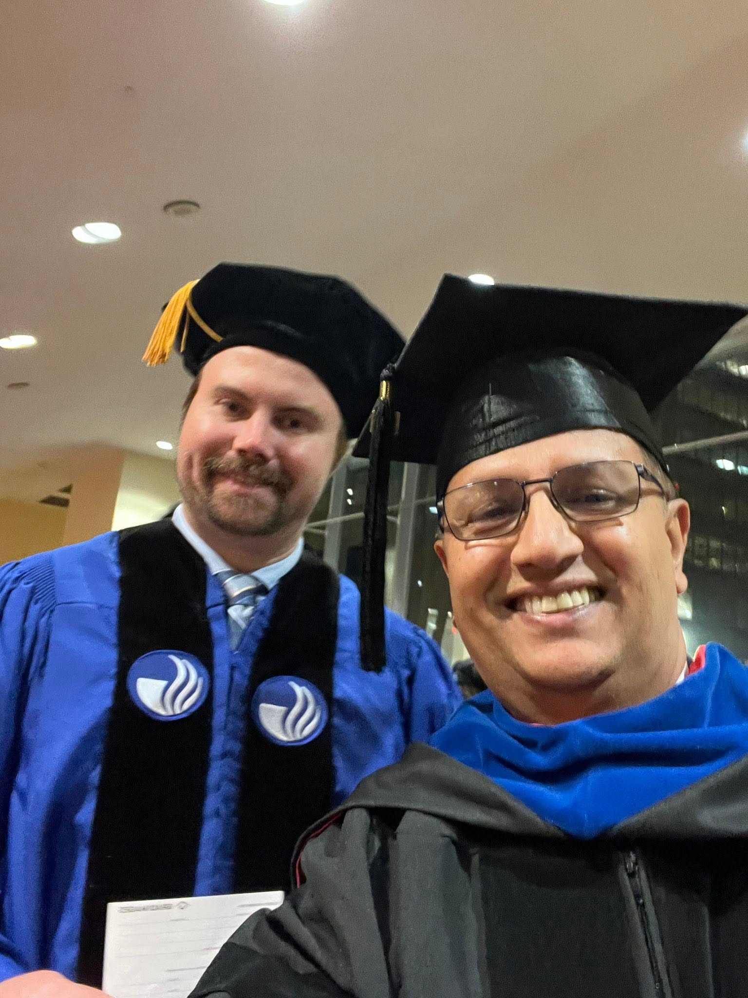 Graduation celebration selfie with Mukesh Dhamala and a student