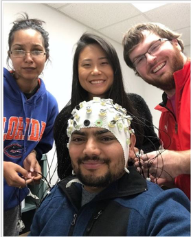 Lab members preparing EEG recording equipment