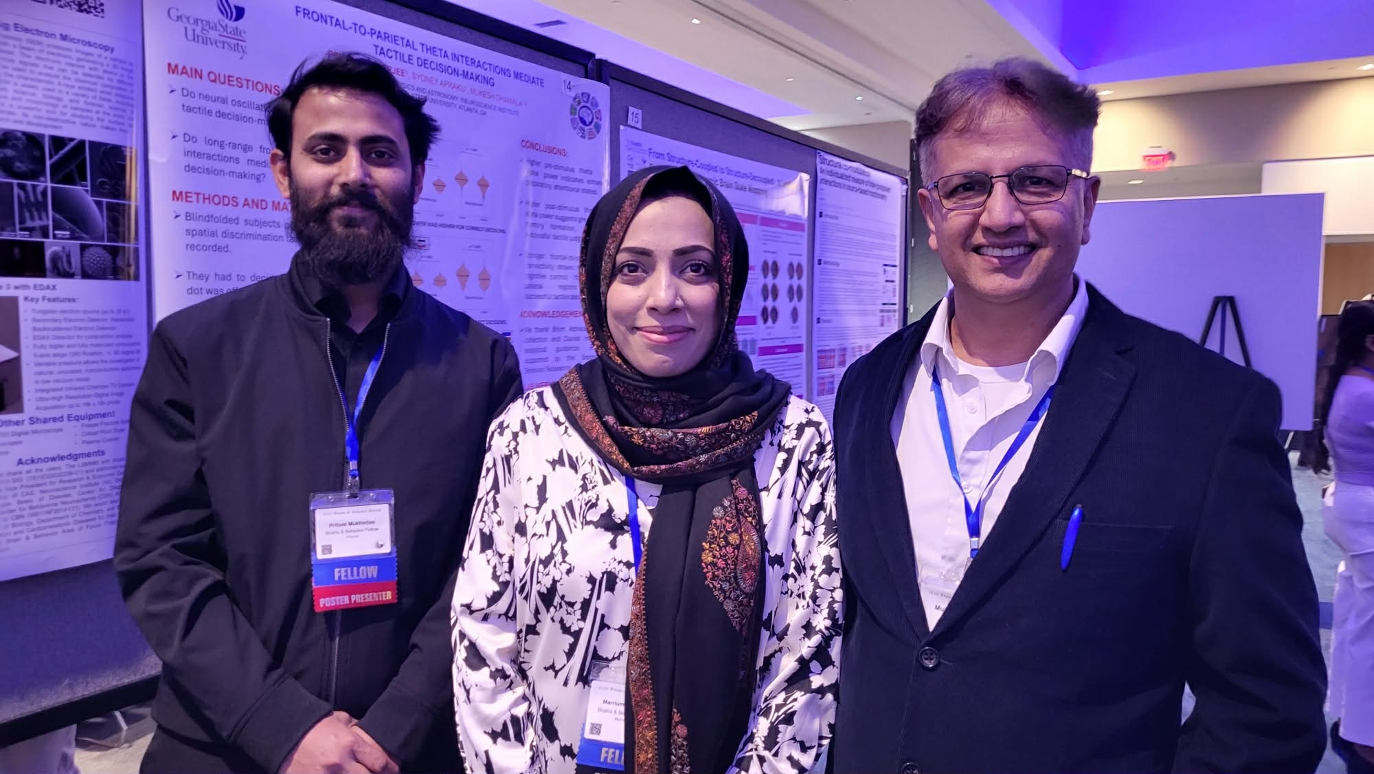 Pritom Mukherjee, Marrium Shamshad, and Mukesh Dhamala at a poster session