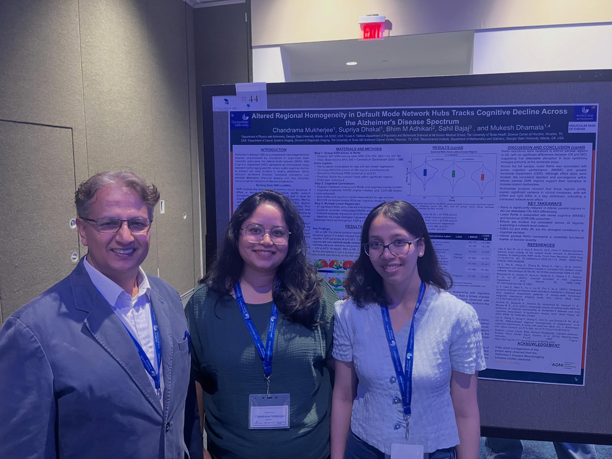 Mukesh Dhamala with students in front of an Alzheimer's disease poster presentation